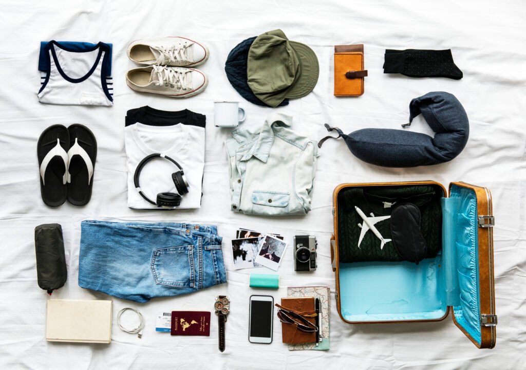 Aerial view of clothes preparing to pack on bed