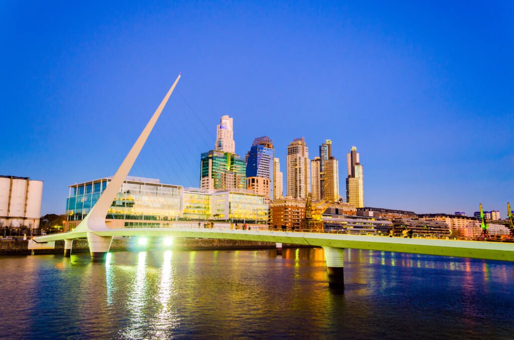 Women's Bridge and upscale skyscrapers at night in Buenos Aires, Argentina