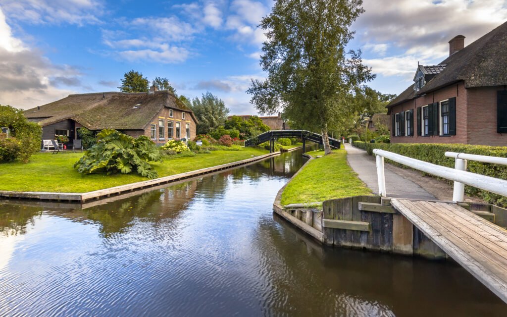 Giethoorn village with canals and rustic thatched roof houses in farm, Netherlands