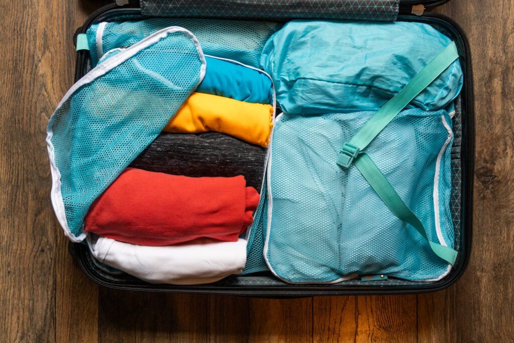 Clothes rolled and packed in small bags