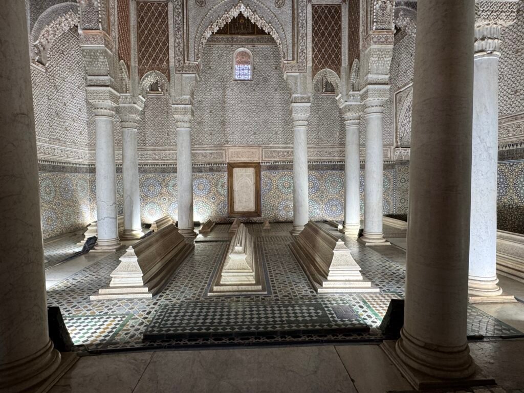 Interior of the Saadian Tombs in Marrakech, showcasing intricate tilework, carved arches, and ornate columns from the 16th century.